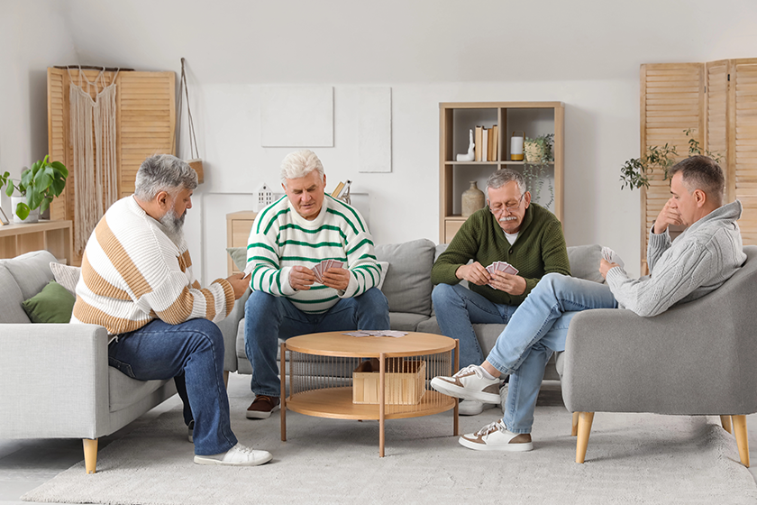 Elderly men playing cards at home