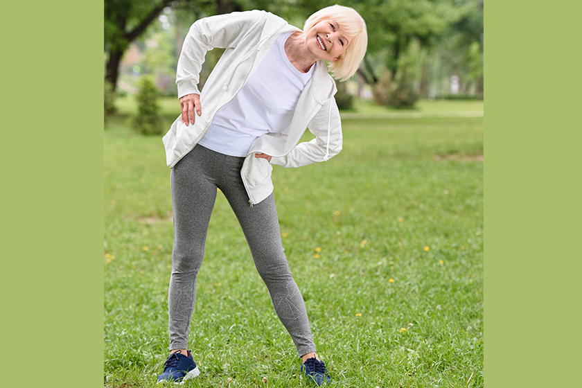 Happy senior sportswoman exercising