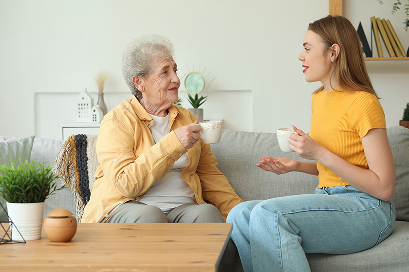 young-woman-her-grandmother-drinking-tea